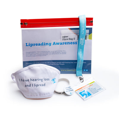 Pack of tools to assist with communication for those who rely on lipreading. Items on display include face covering, wristband, badges and lanyard with communication card.
