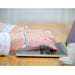 Person wearing white / light grey silicone wristband with black embossed writing 'DEAF - please speak clearly' and Hearing Link logo on white background
