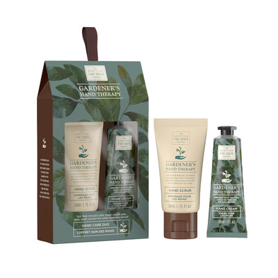 Boxed set next to two products in the set. Box has leaf pattern and transparent window to see products. Products next to box are a cream and brown tube of hand scrub and a smaller leaf pattern tube of hand cream.