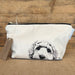 Dog‑illustrated cotton toiletry bag with lined interior and zip, handmade by a UK small business.
