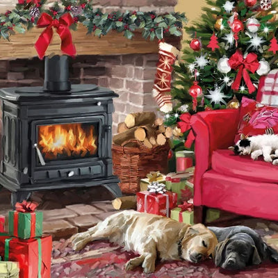 Two labradors snuggled by a wood log burner; the brick mantle decorated for the festive season with a seasonal red bow and stockings either side. Christmas presents fill the room.