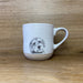 Stoneware mug with a detailed Cooper Cockapoo illustration, weighty feel and matt finish, designed and hand‑finished in the UK.