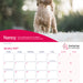 A printed calendar page featuring a large photo of a small curly-haired dog standing outdoors on a white surface, with a pink banner reading 'Nancy' and a January 2027 calendar grid below. The Hearing Dogs for Deaf People logo appears in the lower right.