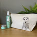 A cotton wash bag with a hand drawn pencil design of a terrier