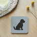 Black Cockapoo or Labradoodle dog coaster on a pale grey background