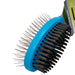 A close up angled view of the brush which shows both side of the brush. The side closest to the camera are the black bristles, with the pin brush being visible on the other side. The body of the brush is a royal blue colour, whilst both sides of the brush are black.