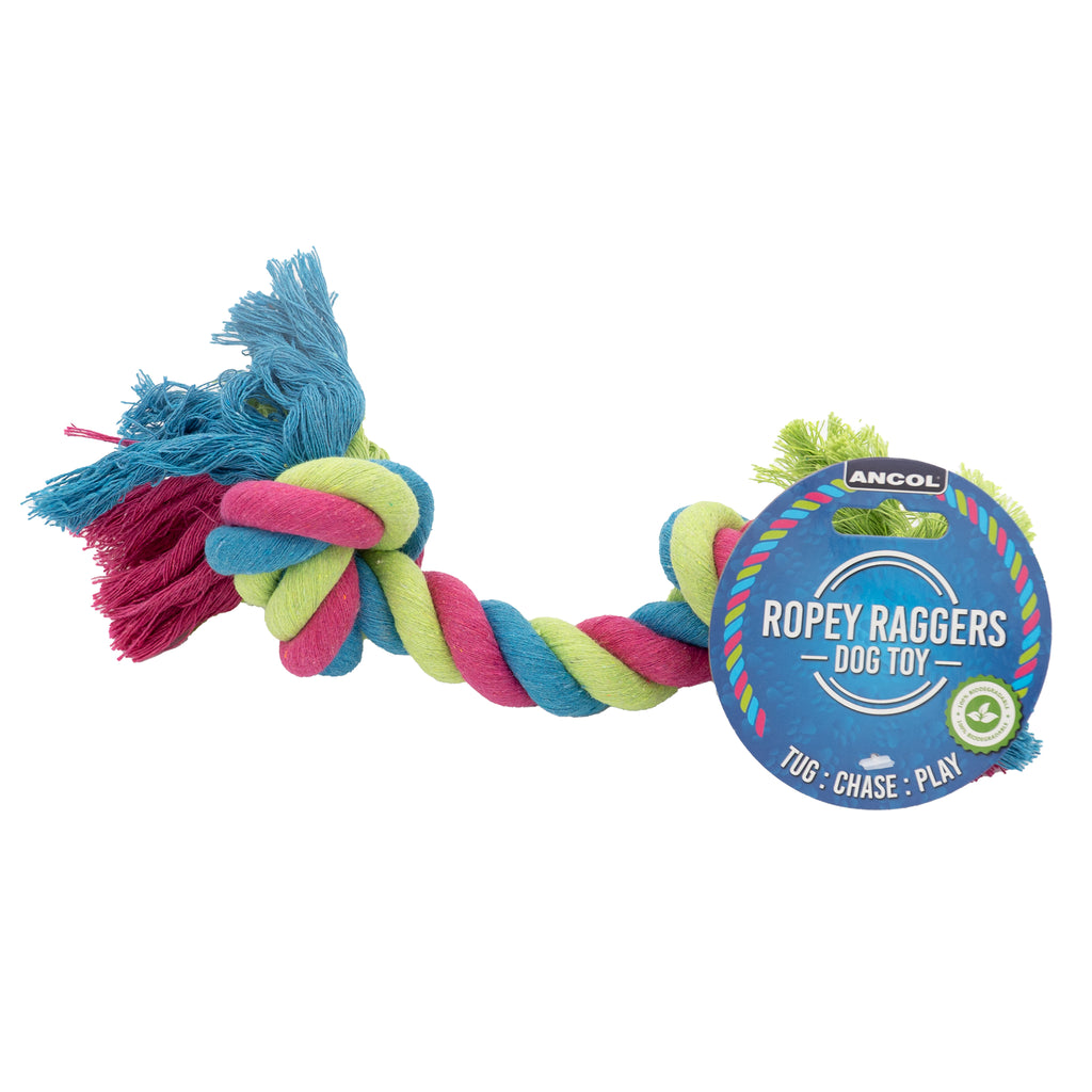 Photo of Ancol's Ropey Raggers Dog Toy. The rope toy is intertwined with red, blue and green rope. The toy has two knots on either end, with a circular blue cardboard label attached to one end. The label has the Ancol logo at the top, along with the name of the product: 'Ropey Raggers Dog Toy'. At the bottom of the label, there is text which reads: 'Tug: Chase: Play'.
