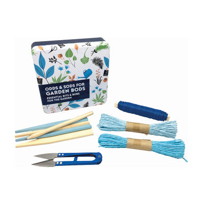 A square tin with illustrations of plants and a watering can on the top, on its side with its contents in front. Contents pictured are two reels of blue twine, mini snips, garden wire, wooden labels and a pencil.