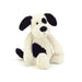 This small children's toy puppy comes with supersoft white fur, black ears and tail and patches of black fur on his body and eye.