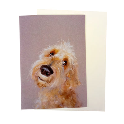  Light brown colourway portrait greeting card, with a beige envelope.  The head of a beautifully illustrated  apricot cockapoo situated in centre of card.  The card has been created by artist Nicky Litchfield. Hearing Dog logo is printed on the back of the card as proceeds from the sale of this card will go to Hearing Dogs for Deaf People.