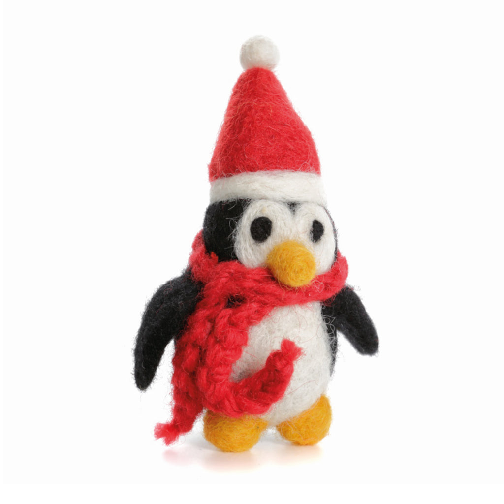 A fuzzy, felt figure of a little penguin wearing a Santa hat and red scarf.