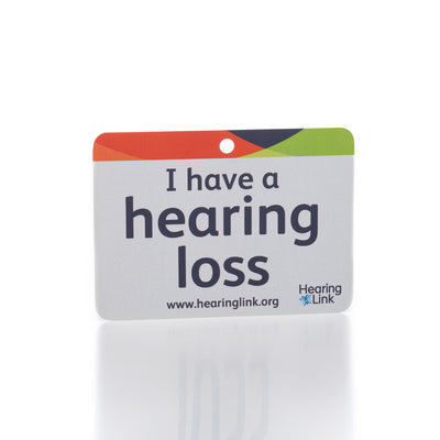 Light grey large print card featuring the dark lettered message 'I have hearing loss' and featuring the Hearing Link logo on white background