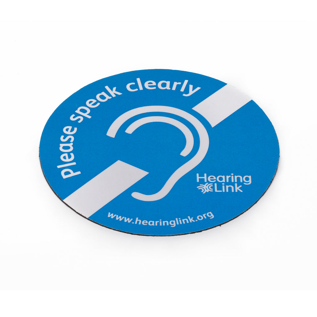 Circular magnetised sign featuring message 'Please speak clearly' and international deaf symbol on white background.