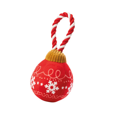 Red Christmas bauble-shaped soft dog toy. The bauble is round with white snowflake decorations, a gold top and a red and white stripy loop for hanging.