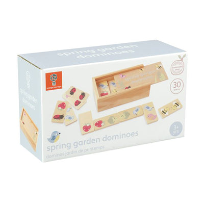A cardboard outer packaging of the spring garden dominoes game, grey box is stood upright. The box features a photo illustrated with wooden dominoes laid out flat, in front of the wooden box which they are stored in. The colourful illustrations on the dominoes and wooden box, include ladybirds, strawberries, hedgehogs and bumblebees. The bottom right hand corner of box, has a circle with white text in it which reads: '3+ yrs'. The Orange Tree Toys logo is in the top left hand corner of the box.