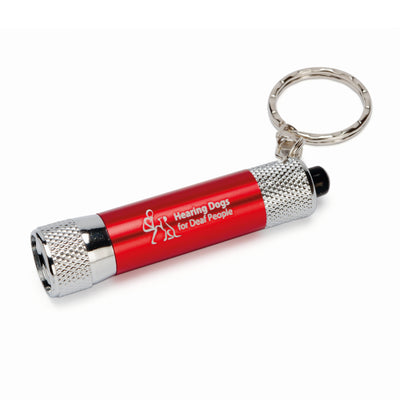 A small silver coloured torch with a red band around the middle showing the Hearing Dogs logo.