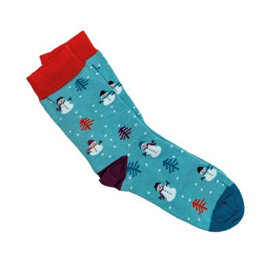 A pair of bamboo socks featuring a repeating snowman and Christmas tree pattern with snowflakes in the background. The socks are teal with a red ankle band, burgundy heel and dark blue toe. 