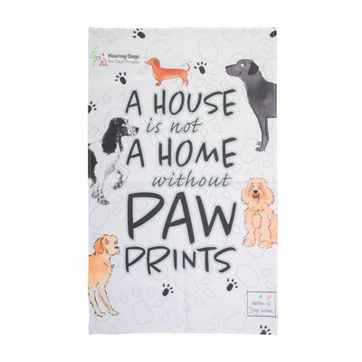 A rectangular towel (portrait) with the words 'A house is not a home without paw prints' written on it with cartoon pictures of dogs and small black paw prints. The dogs are a black labrador, apricot Cockapoo, Golden Retriever, black and white Spaniel and brown Dachshund. Hearing Dogs logo is in the top left corner.