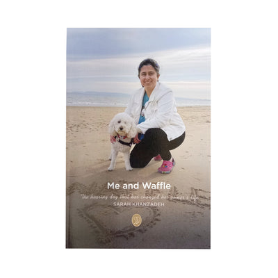 A beautifully written book about Sarah and her Hearing Dog Waffle a white cockapoo. The book charts Sarah's early years, her hearing loss, her surgery, adjusting to school life and meeting her Hearing Dog Waffle who made such a difference to her life. Image shows front cover of  90 page paperbook , with Sarah crouching down on a sandy beach with her Hearing Dog Waffle the cockapoo.